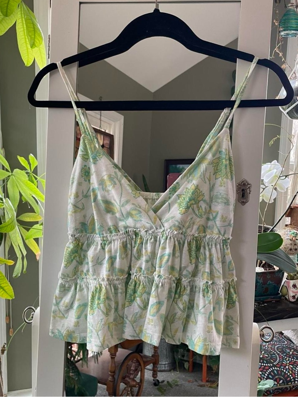 Green floral babydoll top with adjustable straps. Size M